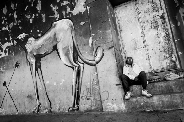 06-jpg mads-norgaard-0027-jpg Person sitting next to graffiti of cheetah, Salt River, 2012